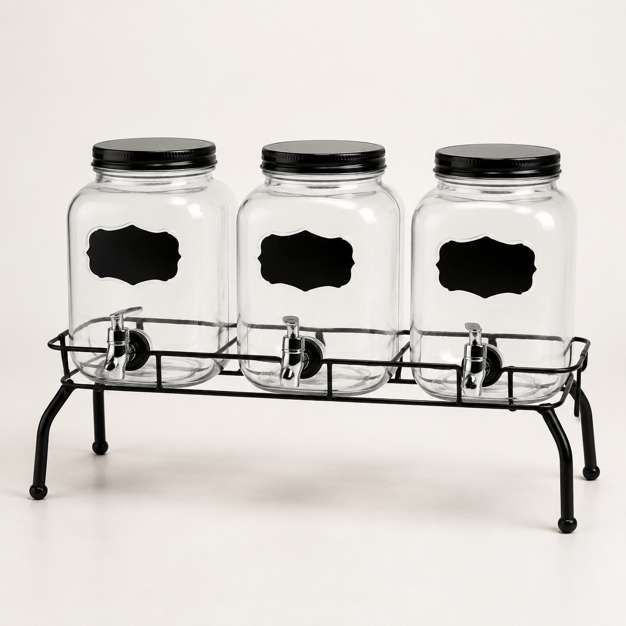 Three glass beverage dispensers on a black metal stand